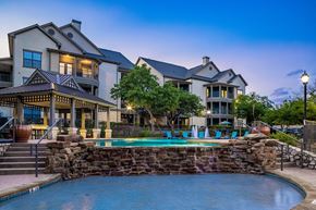 Austin apartment for rent - A large house with a pool in the backyard.