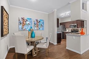 Austin apartment for rent - A dining room with a table and chairs and a painting on the wall.