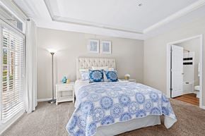 Raleigh apartment for rent - A bedroom with a large bed and a white headboard.