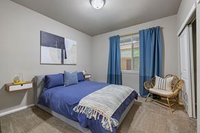 Tacoma apartment for rent - a bedroom with a bed and a chair and a window