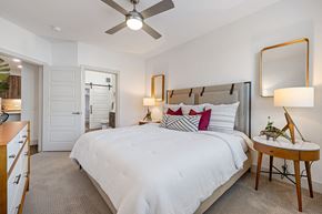 Chandler apartment for rent - a bedroom with a large bed and a ceiling fan