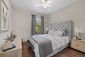 Austin apartment for rent - A bedroom with a large bed and a ceiling fan.