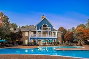 Raleigh apartment for rent - A blue house with a pool in front.