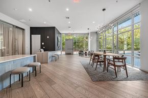 Austin apartment for rent - a dining room with a table and chairs in front of a large window