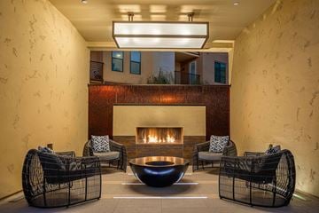 Phoenix apartment for rent - a living room with a fireplace and chairs and a table