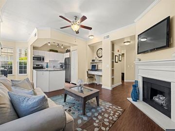 Broomfield apartment for rent - A living room with a grey couch and a fireplace.