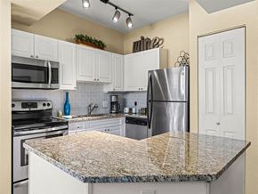Broomfield apartment for rent - A kitchen with a granite countertop and stainless steel appliances.