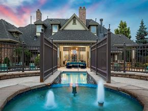 Broomfield apartment for rent - A large house with a pool and a fountain in the middle.