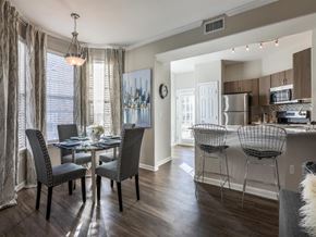 Castle Pines apartment for rent - A dining room with a table set for four and chairs around it.