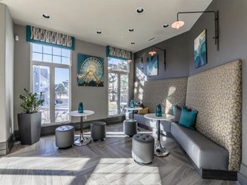 Castle Pines apartment for rent - A modern living room with a grey sofa and a patterned wallpaper.