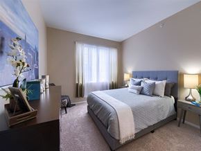 Lakewood apartment for rent - a bedroom with a bed and a dresser and a window
