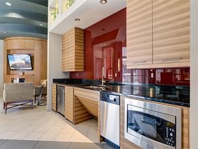 Lone Tree apartment for rent - A modern kitchen with a black countertop and stainless steel appliances.