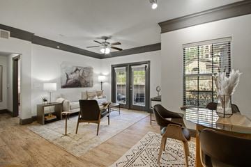 San Antonio apartment for rent - A living room with a glass table and chairs.