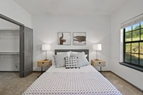 San Antonio apartment for rent - A bedroom with a large bed and two lamps.