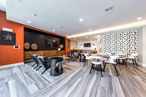 Houston apartment for rent - a dining room with tables and chairs and a tv