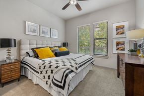 Austin apartment for rent - a bedroom with a bed and a ceiling fan