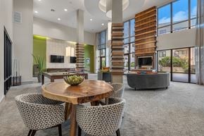 Austin apartment for rent - A modern dining room with a round wooden table and chairs.