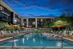 Austin apartment for rent - a swimming pool at night in front of an apartment building