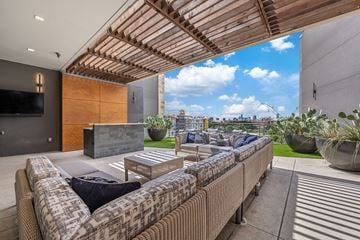 Austin apartment for rent - A modern outdoor living space with a couch and a television.