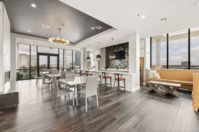 Houston apartment for rent - A modern dining room with a large table and chairs.