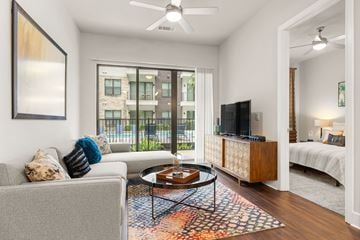 Houston apartment for rent - A living room with a grey couch and a coffee table.
