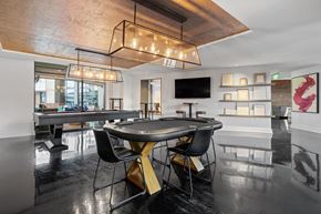Nashville apartment for rent - a black table with chairs in a room with a pool table and a television
