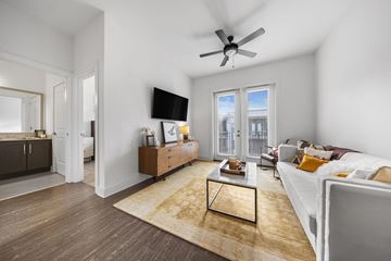 Nashville apartment for rent - A living room with a white couch and a wooden coffee table.