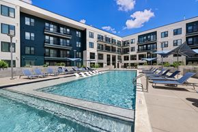 Austin apartment for rent - A large swimming pool in front of apartment buildings.