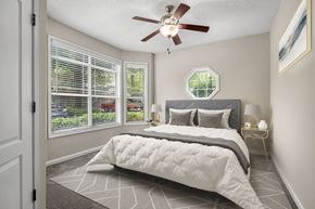 Atlanta apartment for rent - A bedroom with a large bed and a ceiling fan.