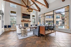 Austin apartment for rent - A modern living room with a fireplace and a large window.