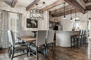 San Antonio apartment for rent - a dining area with a wooden table and chairs and a kitchen in the background