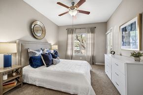 San Antonio apartment for rent - a bedroom with a large bed and a ceiling fan
