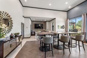 Frisco apartment for rent - A modern dining room with a dark wood floor and a large mirror on the wall.