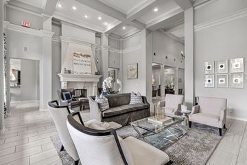 Fort Worth apartment for rent - A living room with a grey couch and a glass coffee table.
