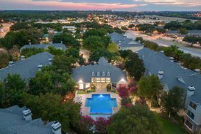 Fort Worth apartment for rent - A large house with a pool in the middle of a garden.