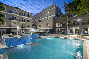 Dallas apartment for rent - A large swimming pool in front of apartment buildings.