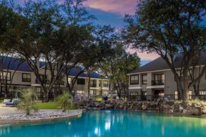 Richardson apartment for rent - A beautiful view of a resort with a pool and trees.