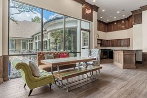 Richardson apartment for rent - A modern kitchen with a green chair and a wooden table.