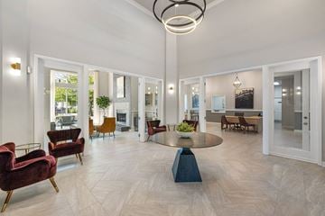 Charlotte apartment for rent - A spacious living room with a round table and chairs.