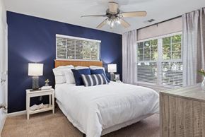 Morrisville apartment for rent - a bedroom with a large bed and a ceiling fan