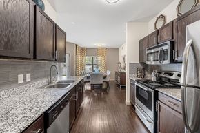 Cedar Park apartment for rent - a view of a kitchen and a living room with wood floors
