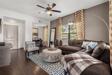 Cedar Park apartment for rent - A living room with a brown couch and a patterned rug.