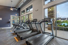 San Antonio apartment for rent - A gym with treadmills and a view of the outside.