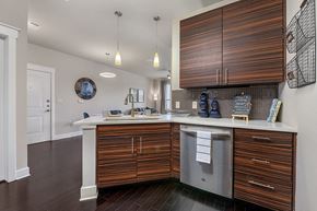 San Antonio apartment for rent - A kitchen with wooden cabinets and a white counter.