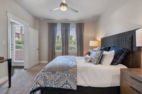 San Antonio apartment for rent - A bedroom with a large bed and a ceiling fan.