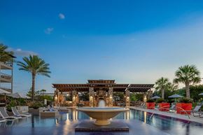 San Antonio apartment for rent - A luxurious poolside setting with a fountain at the center.
