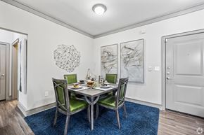 Katy apartment for rent - A dining room with a table set for two and a blue rug.