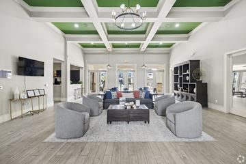 Katy apartment for rent - A spacious living room with a grey sofa set and a coffee table in the center.