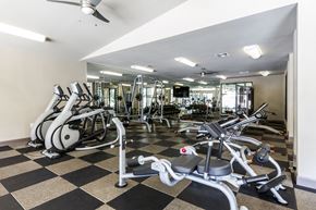 Austin apartment for rent - A gym with a variety of exercise equipment including treadmills, stationary bikes, and weight machines.