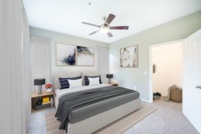 Houston apartment for rent - A bedroom with a large bed and a ceiling fan.